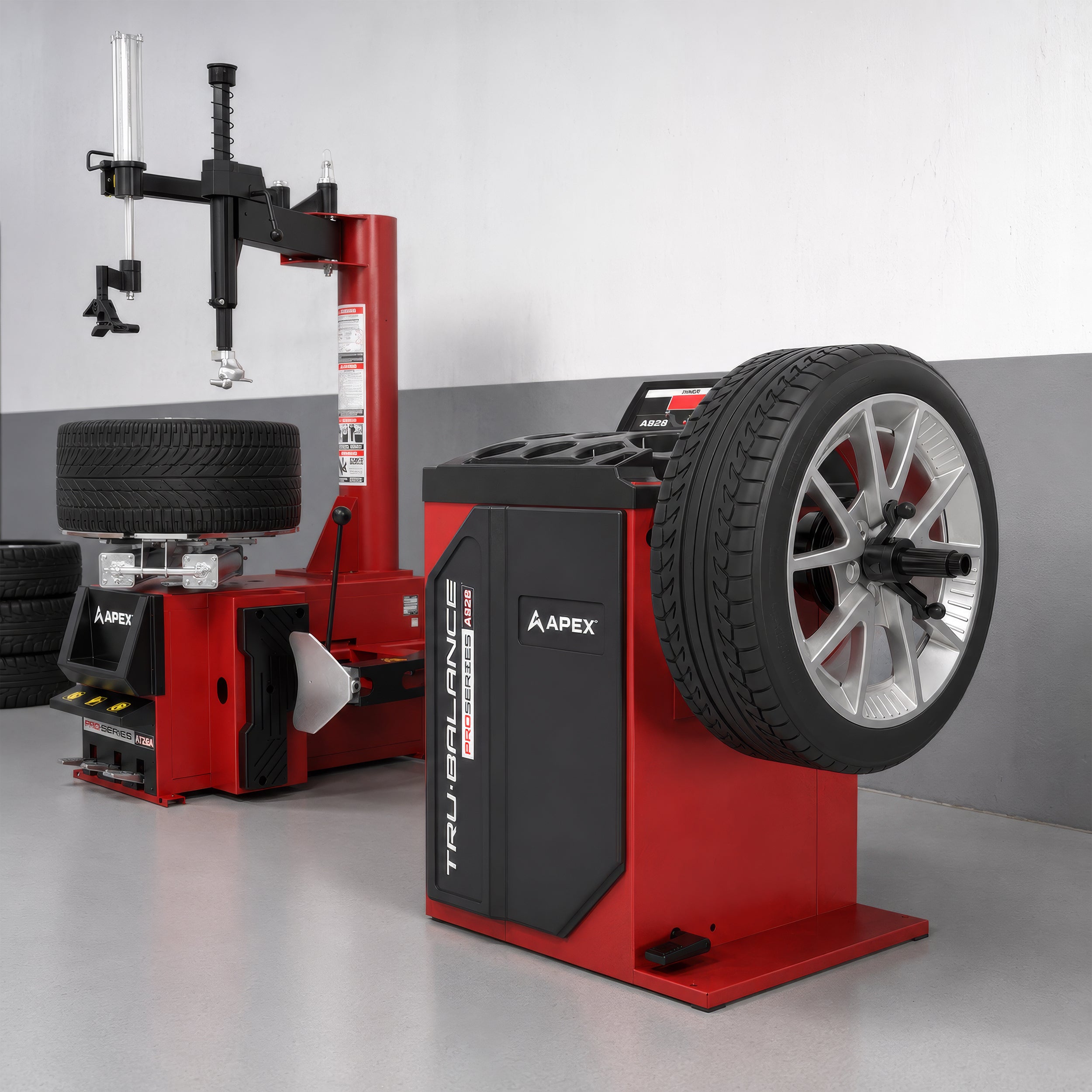 APEX AB28 wheel balancer and AT26A tire changer combo positioned in a professional mechanic shop.