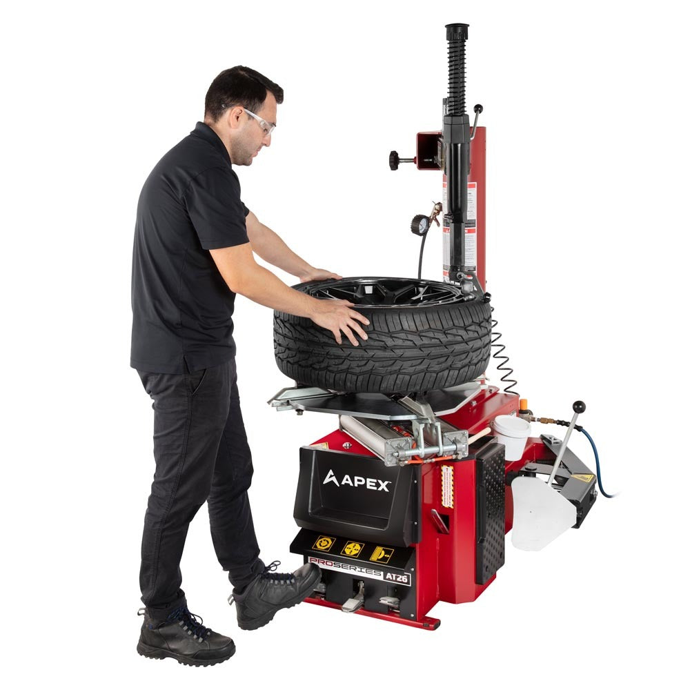 APEX AT26 professional swing-arm tire changer for mounting and demounting automotive tires.