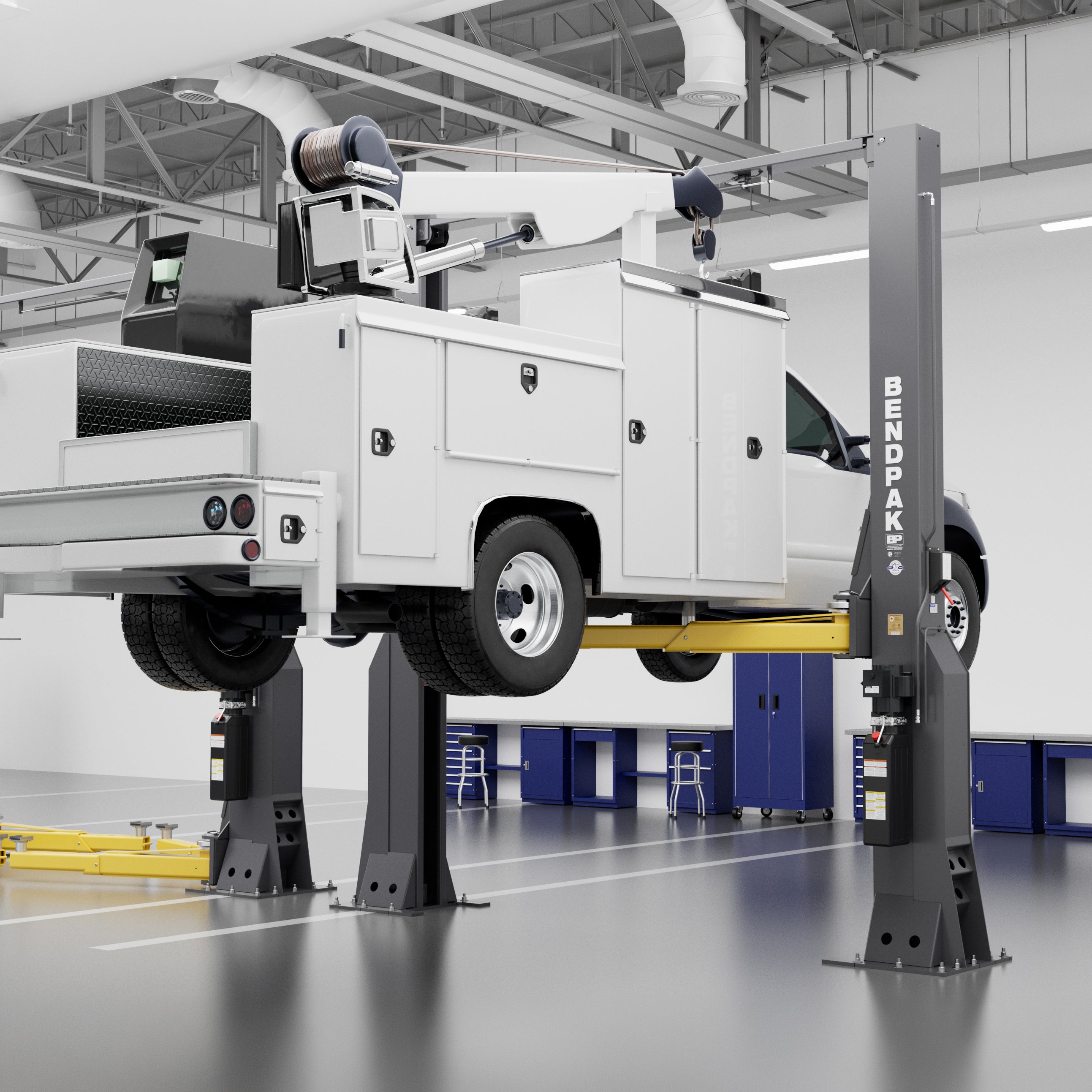 BendPak 16AP 16,000-lb. two-post lift raising a large service truck in a commercial shop.