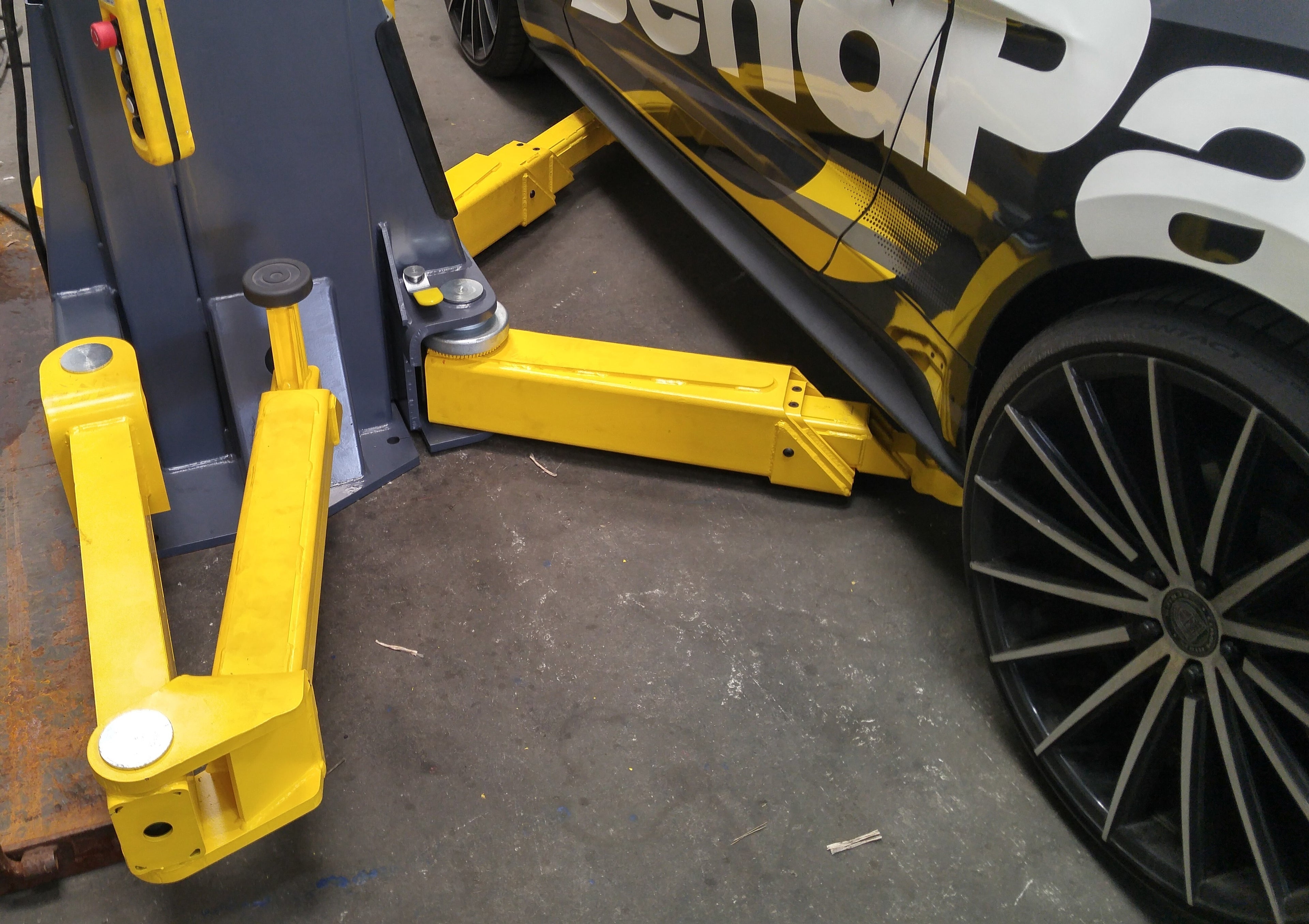 BendPak EV12DPS 12,000-lb. two-post EV lift with auxiliary arms for battery and cab-off service