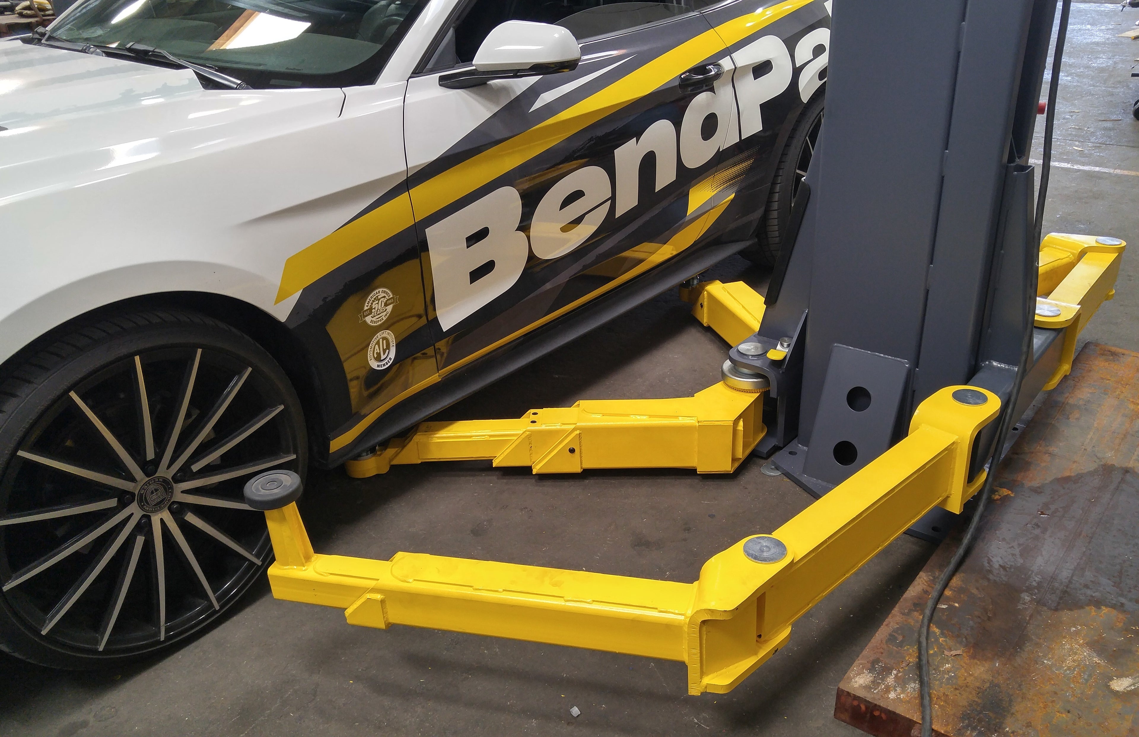 BendPak EV12DPS EV lift shown from a low perspective with a 12,000-lb. capacity two-post design