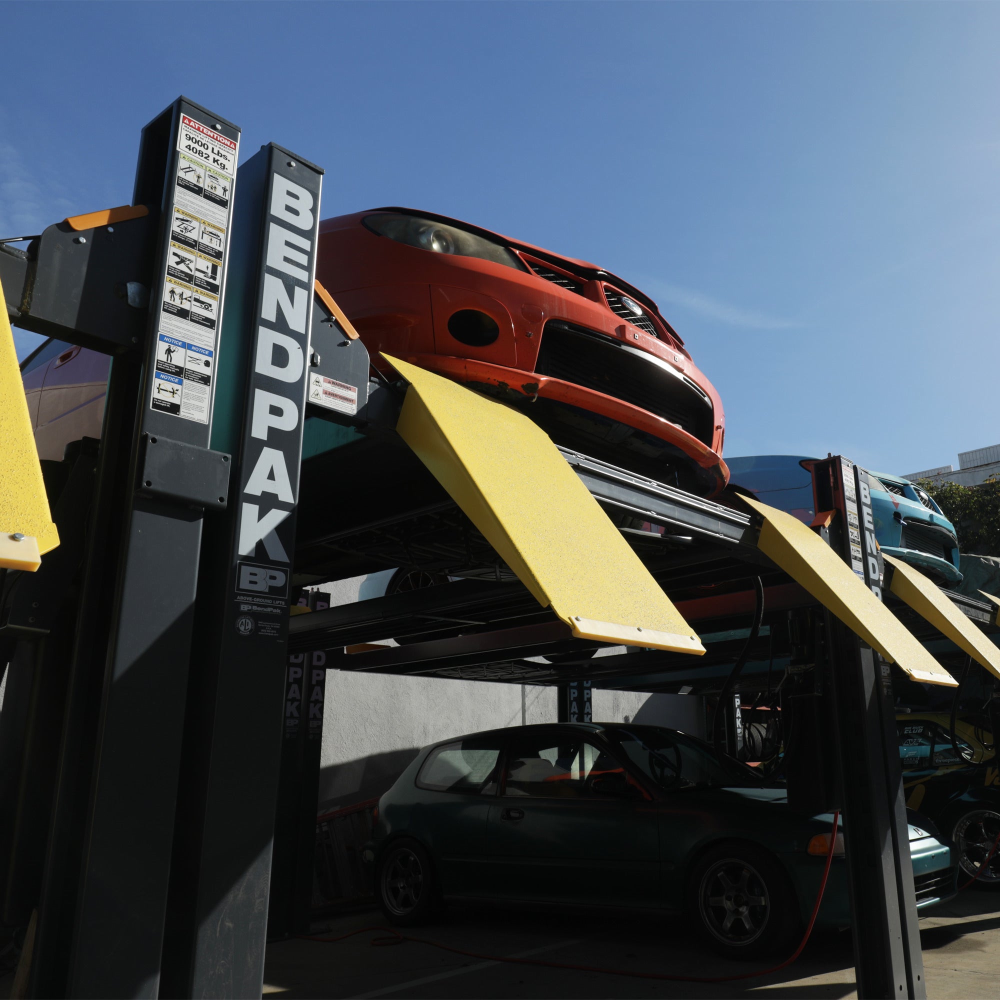 BendPak HD-9 four-post vehicle lift for space-saving parking and underbody access