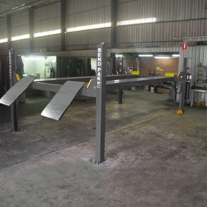 BendPak HD-9STX four-post garage lift with narrow extended platform layout