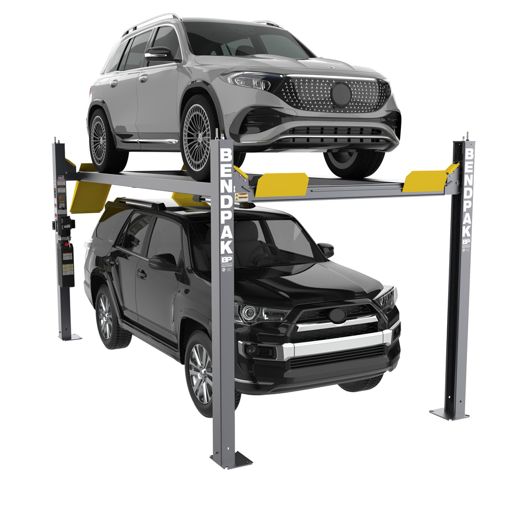 BendPak HD-9STX four-post parking lift storing two SUVs with one vehicle elevated above the other for space-saving garage storage.