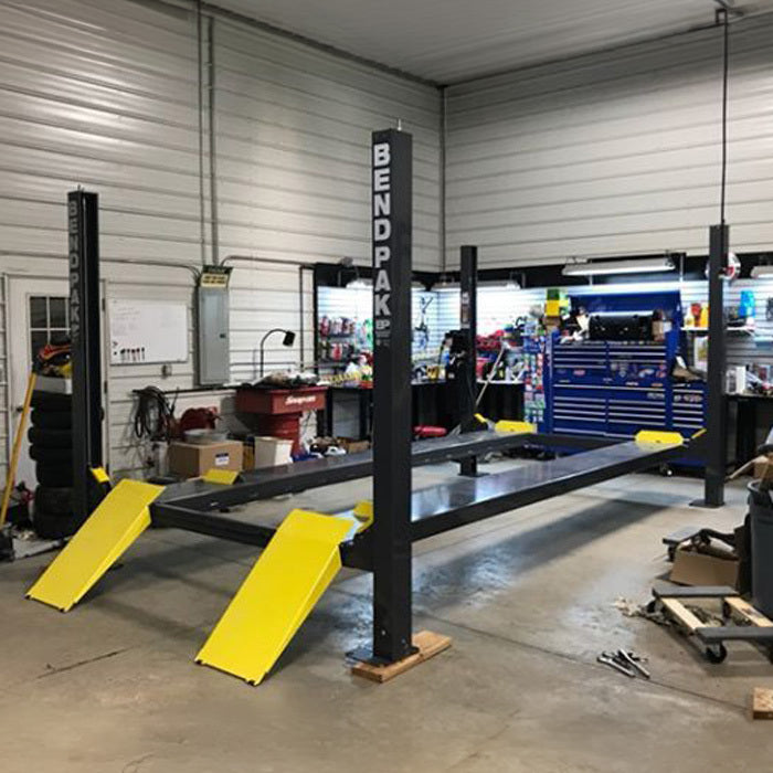 BendPak HD-9XW 9,000-lb. four-post lift for wide vehicles and garage parking.