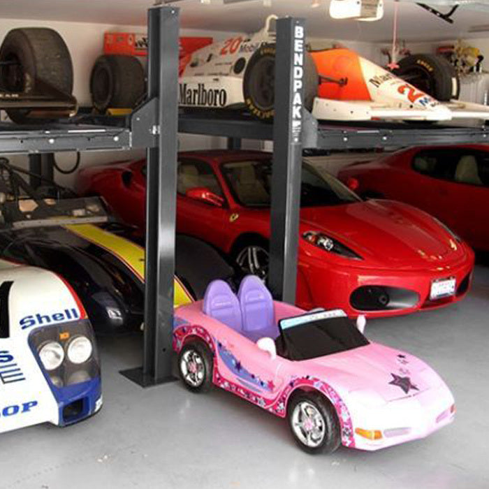 BendPak HD-9XW four-post lift for garage vehicle storage and maintenance access.