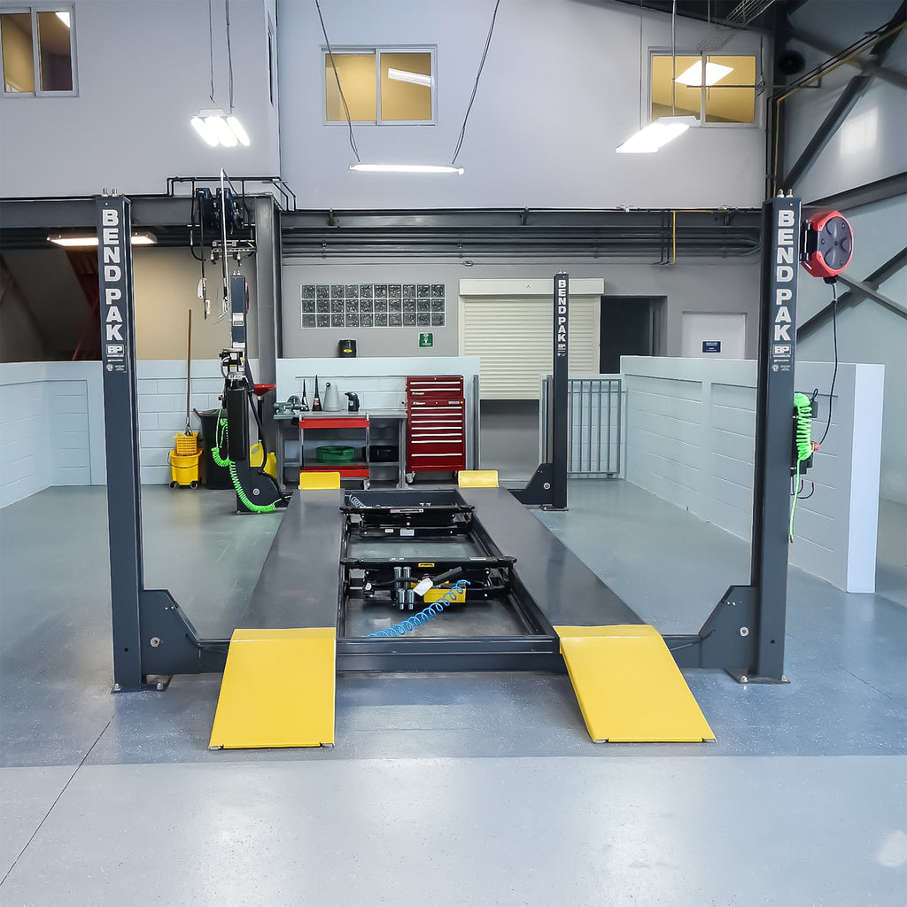BendPak HDS-14 four-post lift in an industrial mechanic shop service bay.