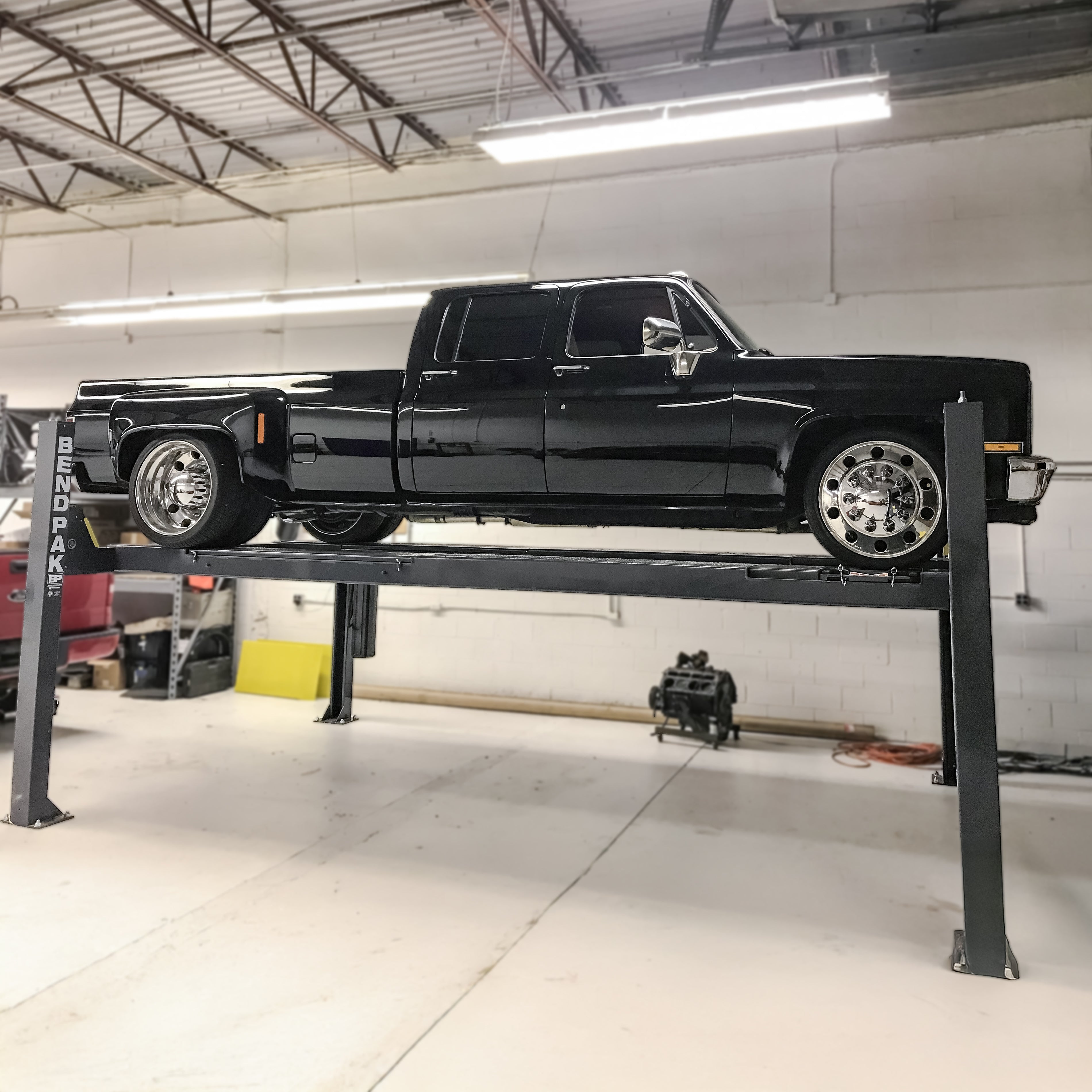 BendPak HDS-14LSXE extended alignment lift supporting a classic dually truck.