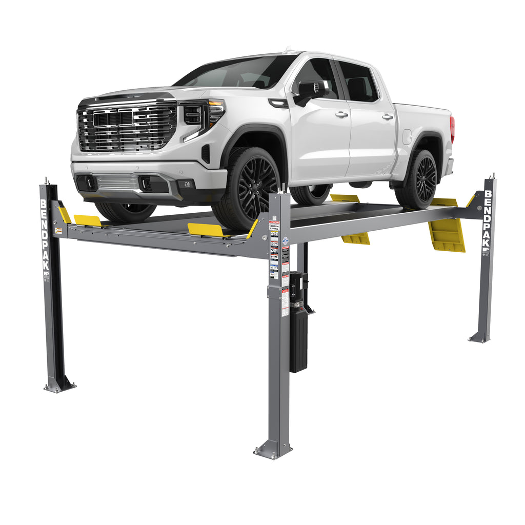 BendPak HDS-14 four-post lift supporting a white truck in a service bay.