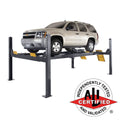 BendPak HDS-14LSXE extended alignment lift supporting a limousine with turnplate and slip plate access.
