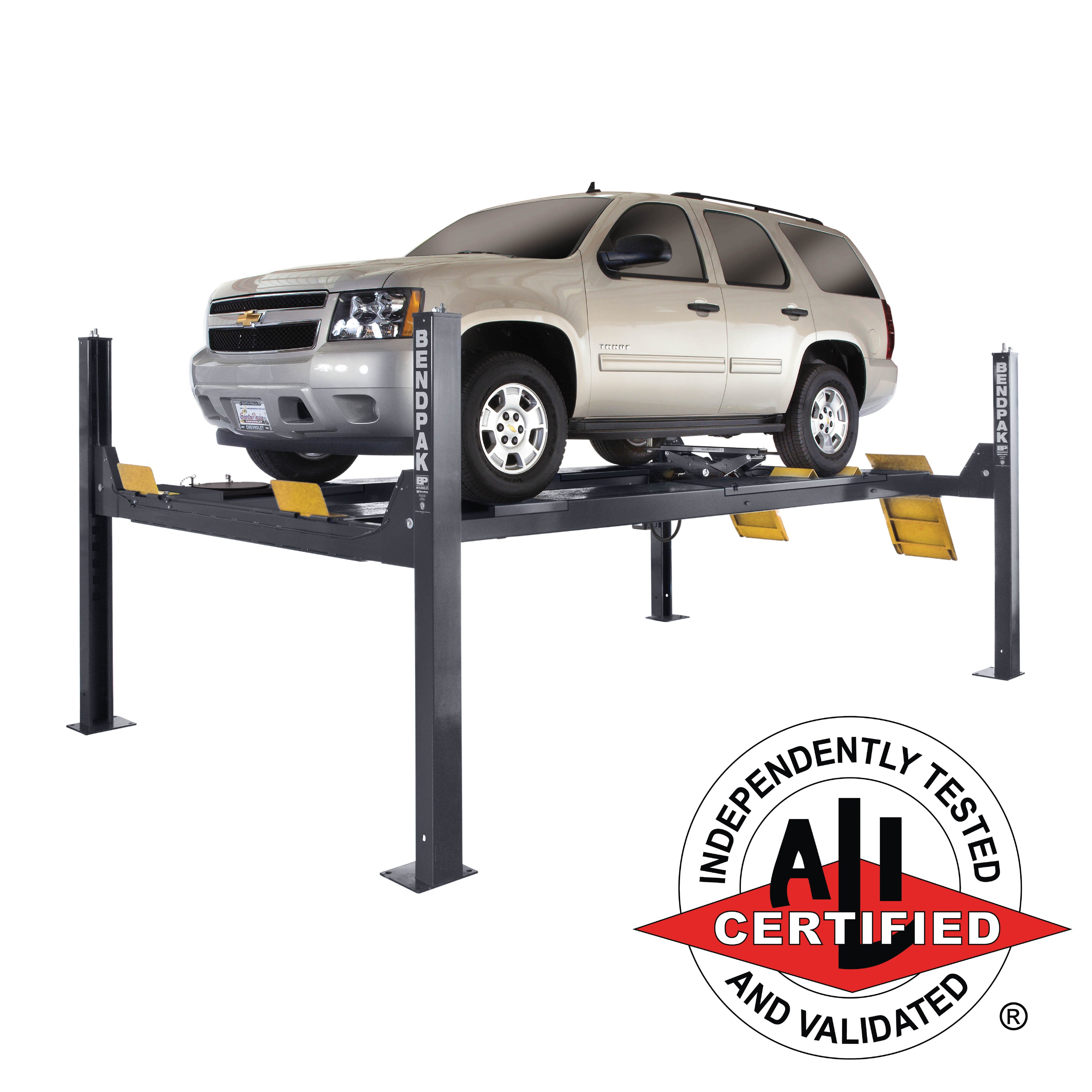 BendPak HDS-14LSXE extended alignment lift supporting a limousine with turnplate and slip plate access.