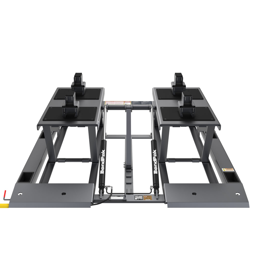 BendPak LR-10000 low-rise lift showing integrated drive-over ramps and dual hydraulic cylinders.