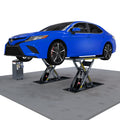 Sedan raised on a BendPak MDS-6LPF open-center flush-mount mid-rise scissor lift with a 6,000-lb. capacity and control console.