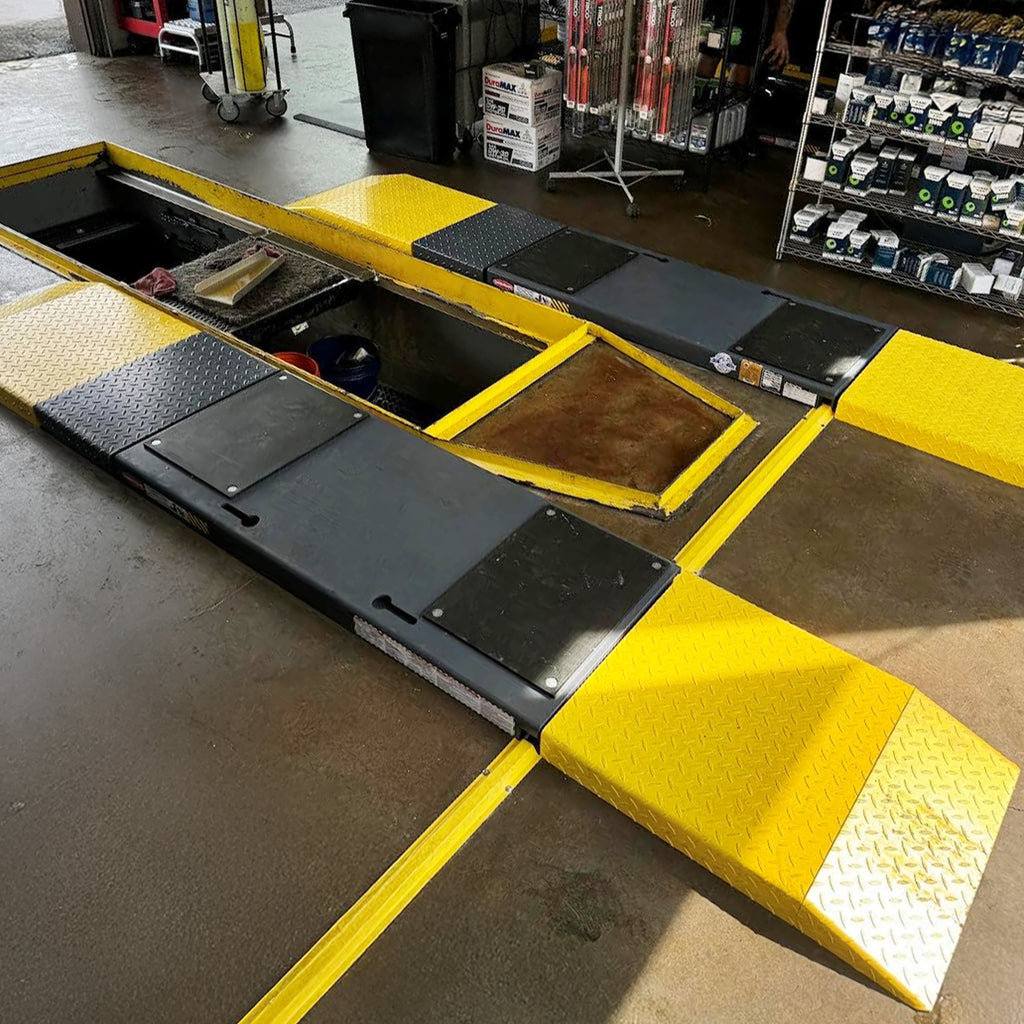 BendPak P-9000LT low-rise frame-engaging lift in use for undercar vehicle service.