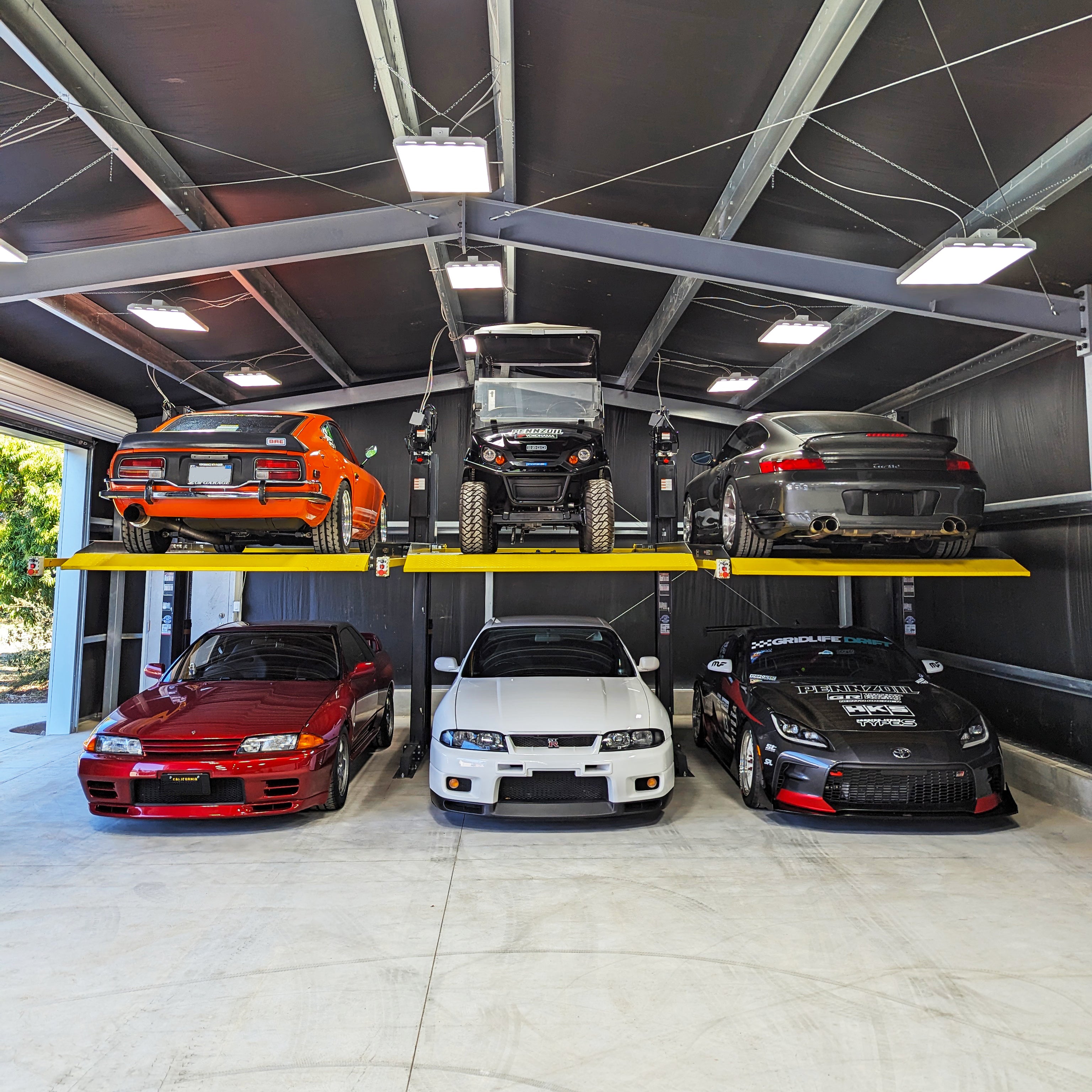 BendPak PL6000DC daisy-chained shared-column two-post parking lift system.