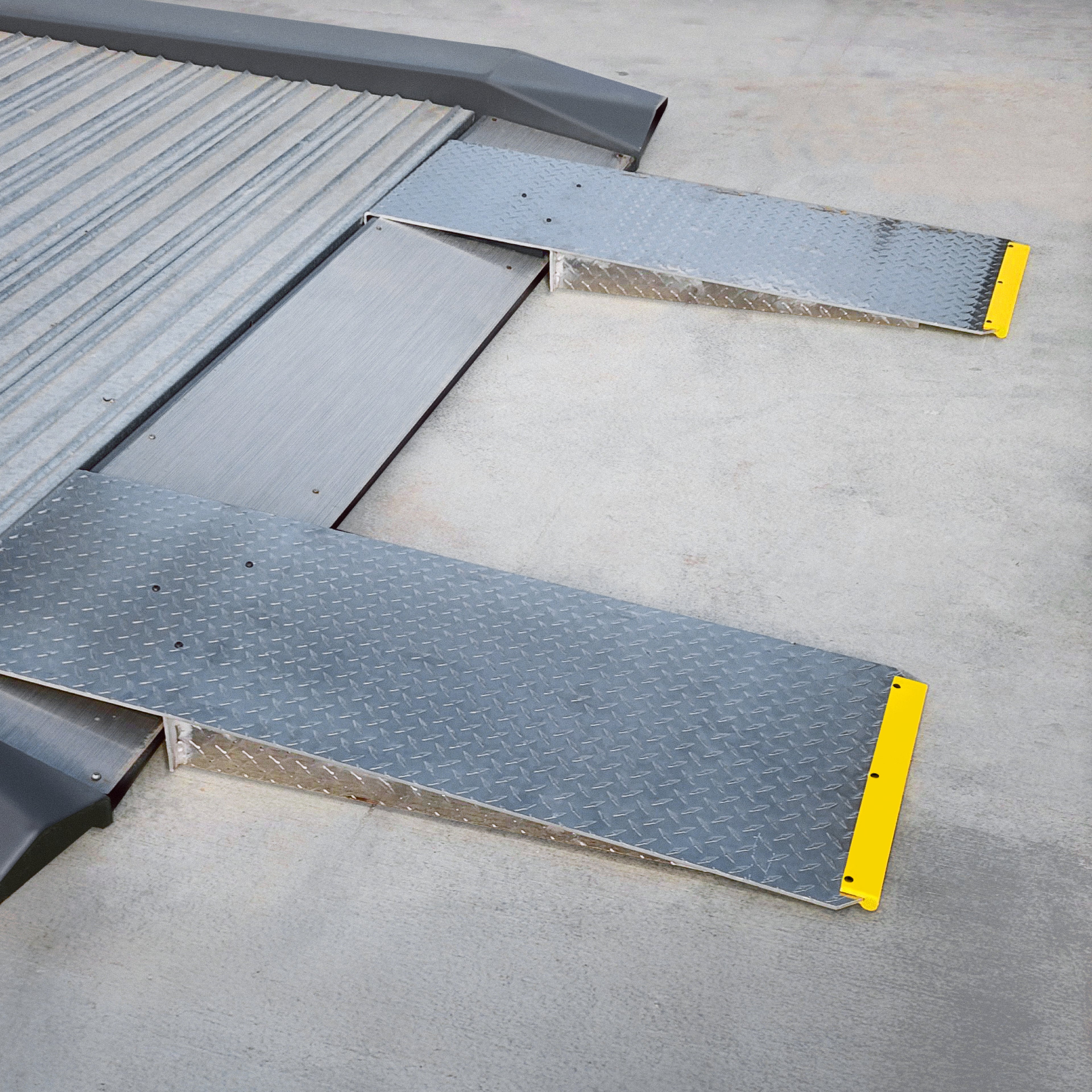 Extended aluminum approach ramps mounted to a BendPak PL-6000DC or PL-6000DCX parking lift.