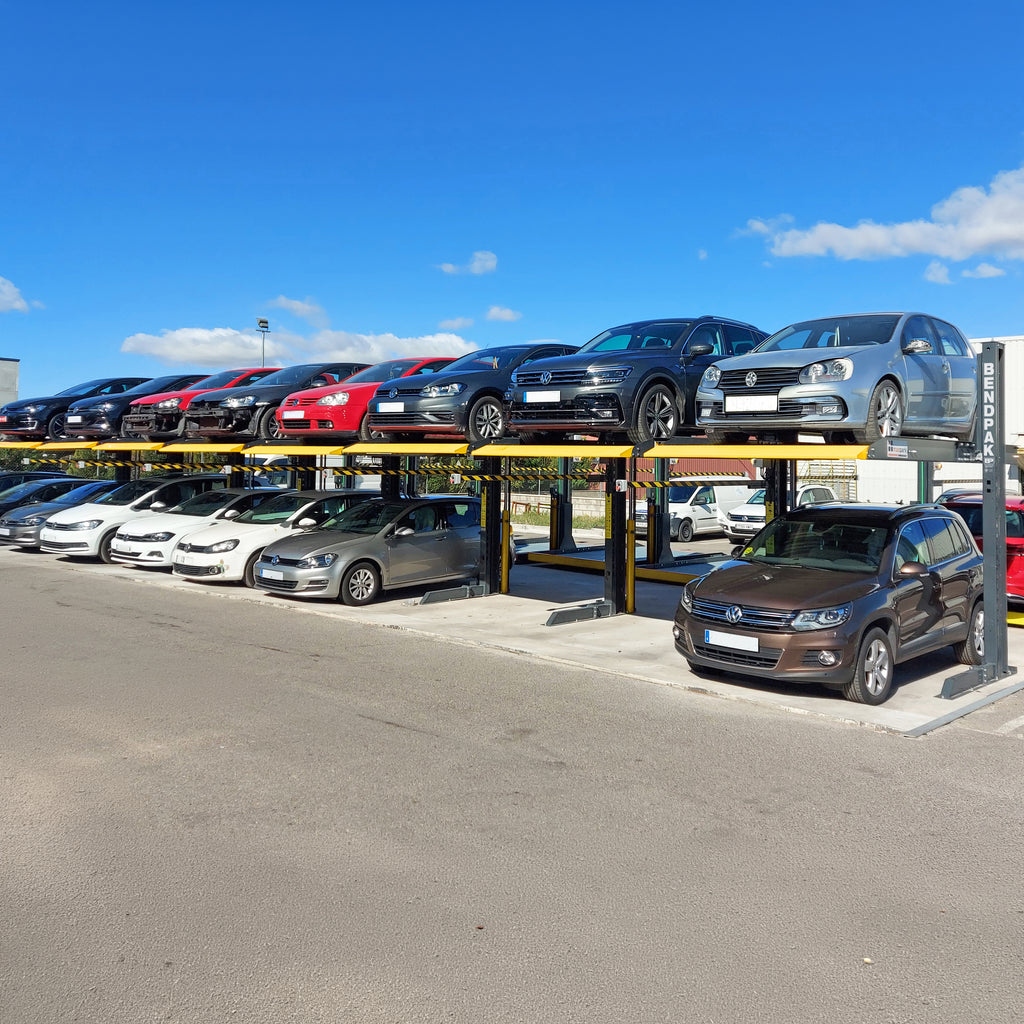 BendPak PL6000DC shared-column parking lift with a space-saving minimal footprint.