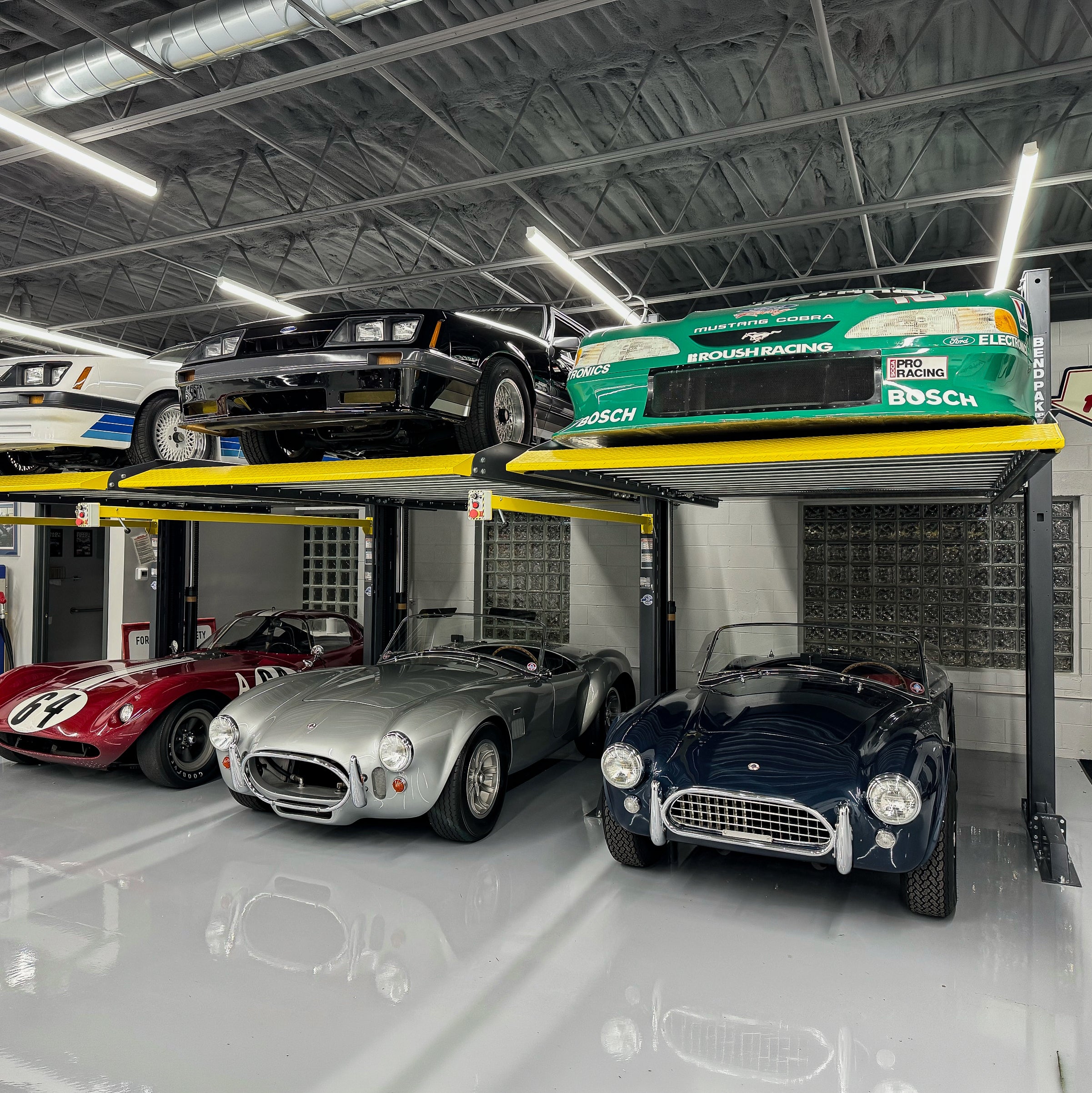 BendPak PL6000DCX shared-column parking lift system for storing vehicle collections.