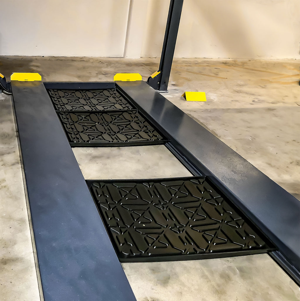 BendPak four-post lift plastic drip trays protecting vehicles below