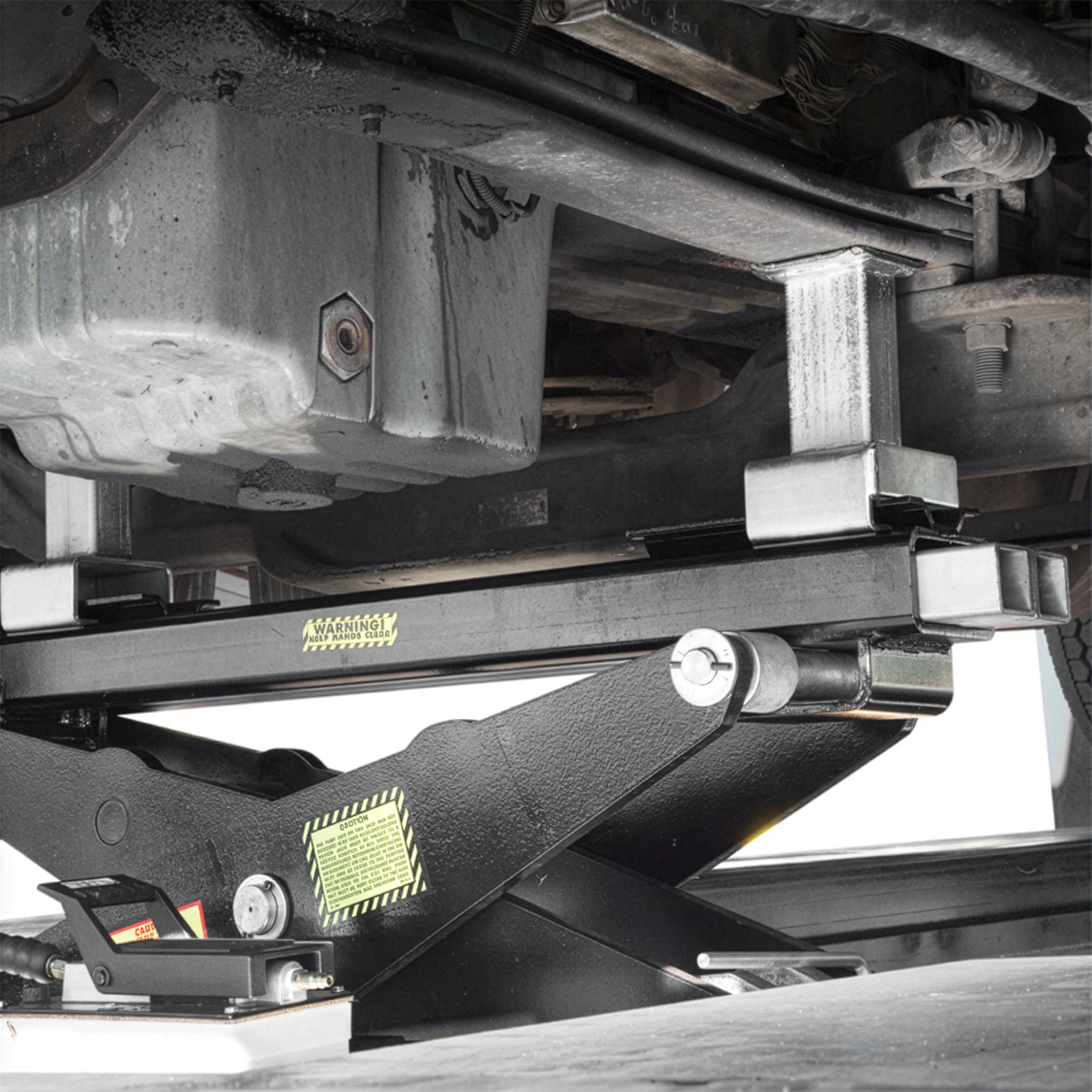 BendPak RBJ15000 rolling bridge jack lifting a heavy semi chassis for service access.