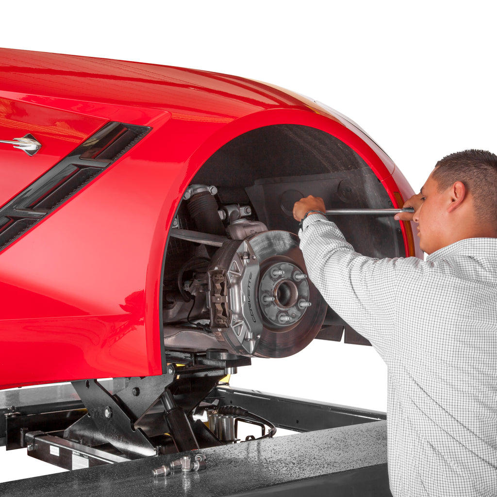 BendPak RJ45LP low-profile rolling bridge jack lifting a sports car on a four-post lift.