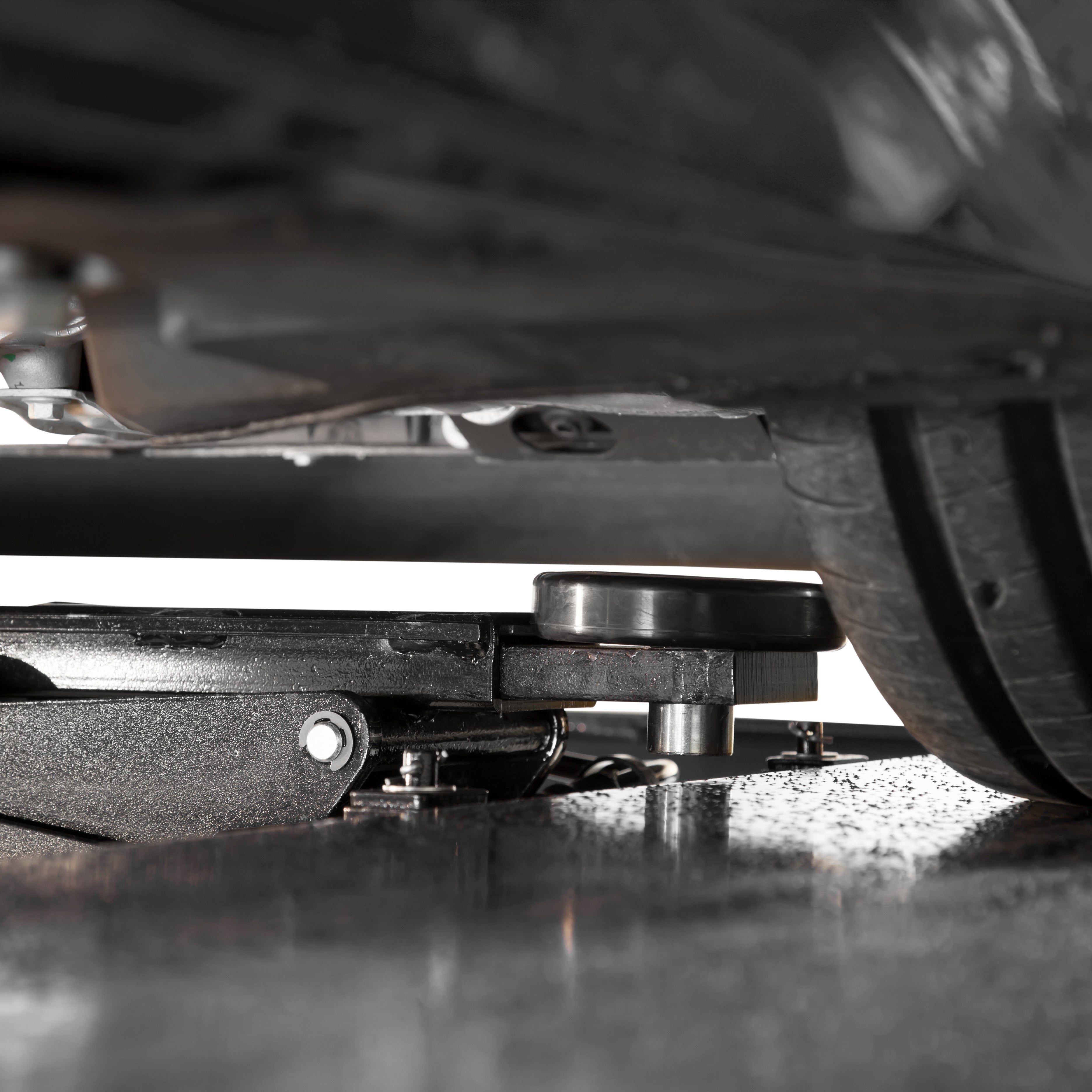 BendPak RJ45W rolling bridge jack positioned under a sports car for undercarriage access.