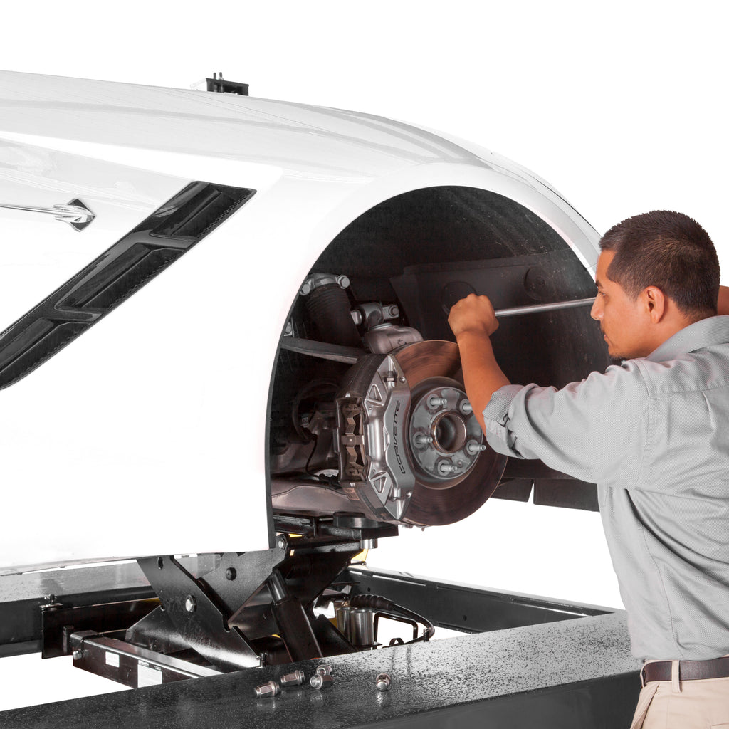 BendPak RJ6W rolling bridge jack supporting a sports car during brake pad service.
