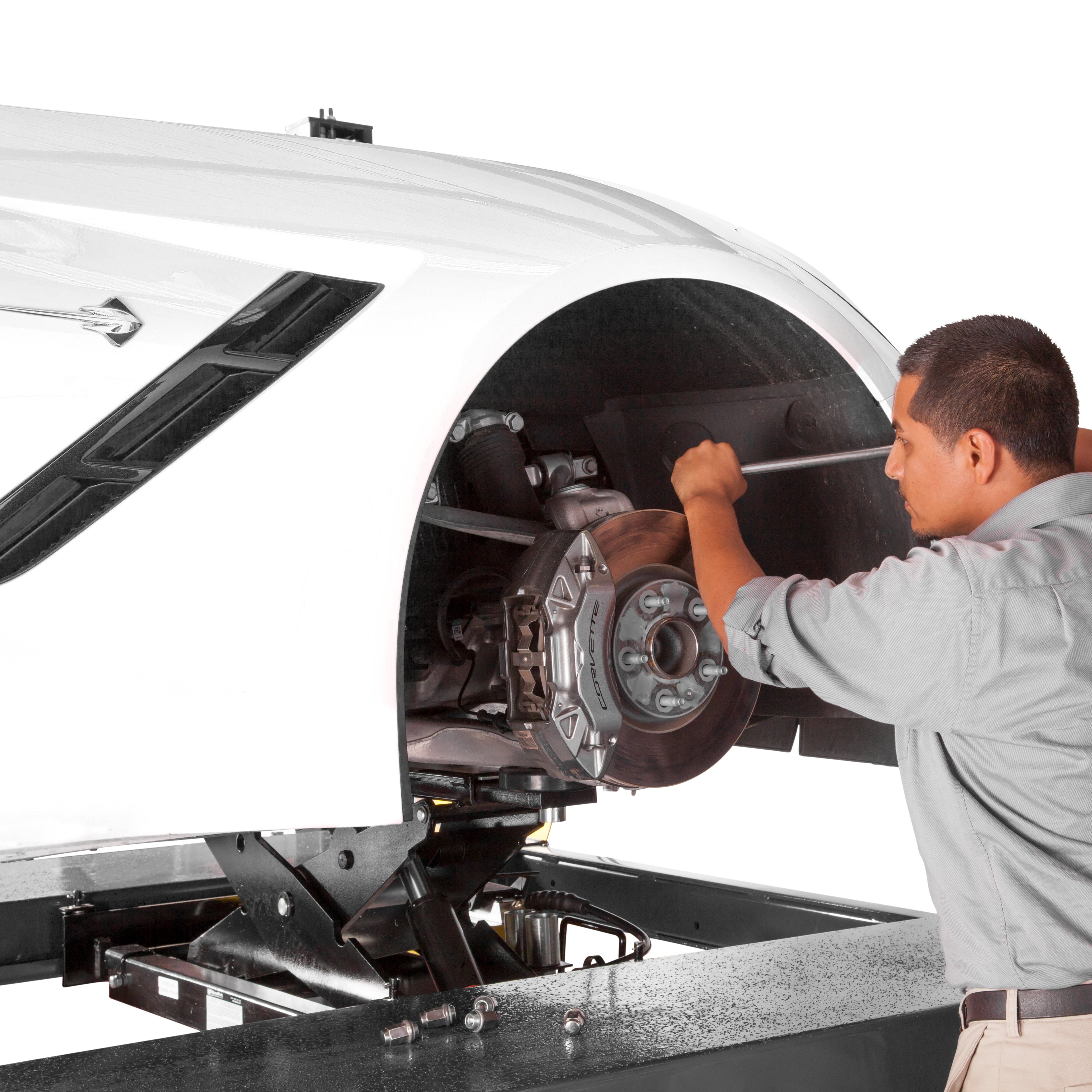 BendPak RJ6W rolling bridge jack supporting a sports car during brake pad service.