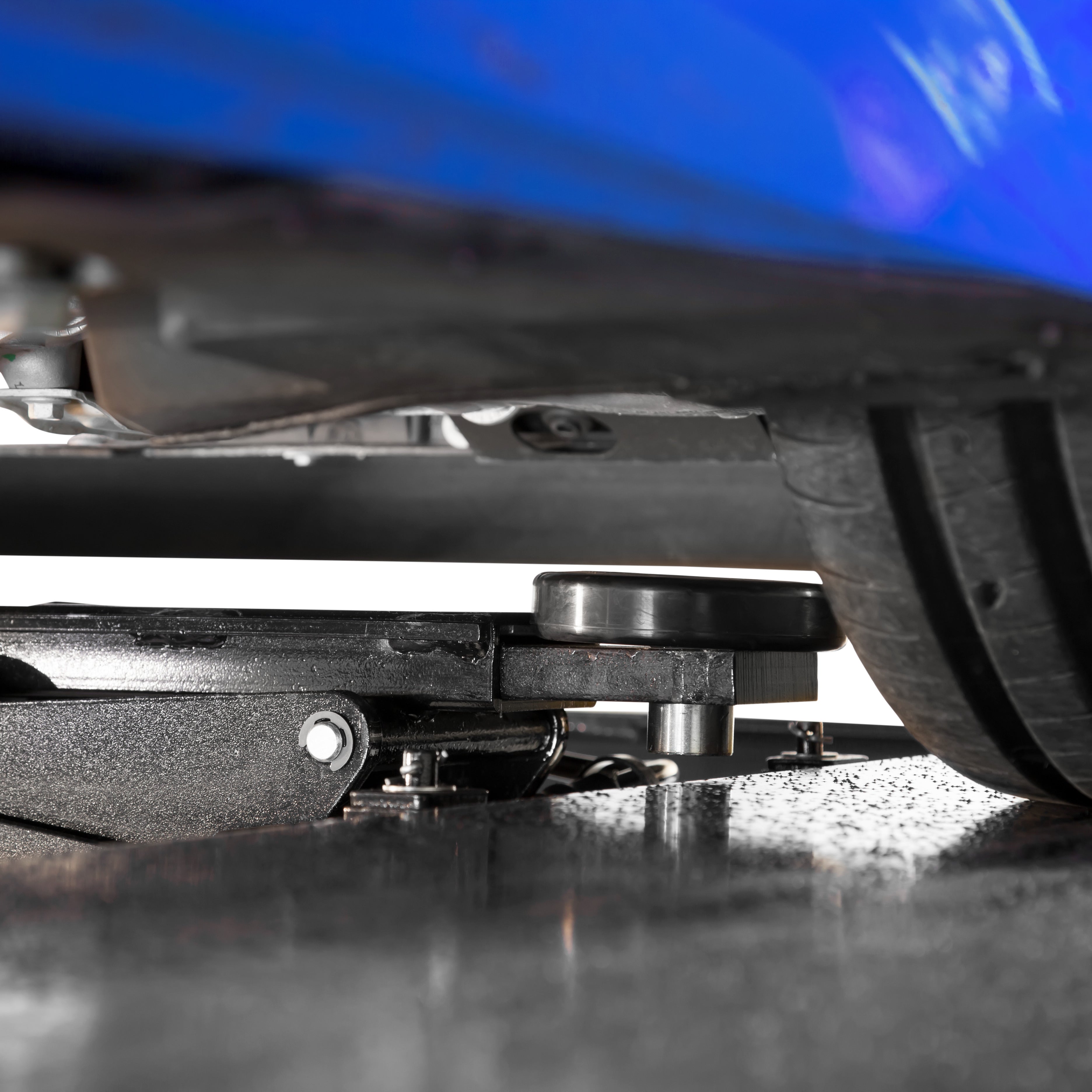 BendPak RJ7W rolling bridge jack positioned under a sports car for underbody service.
