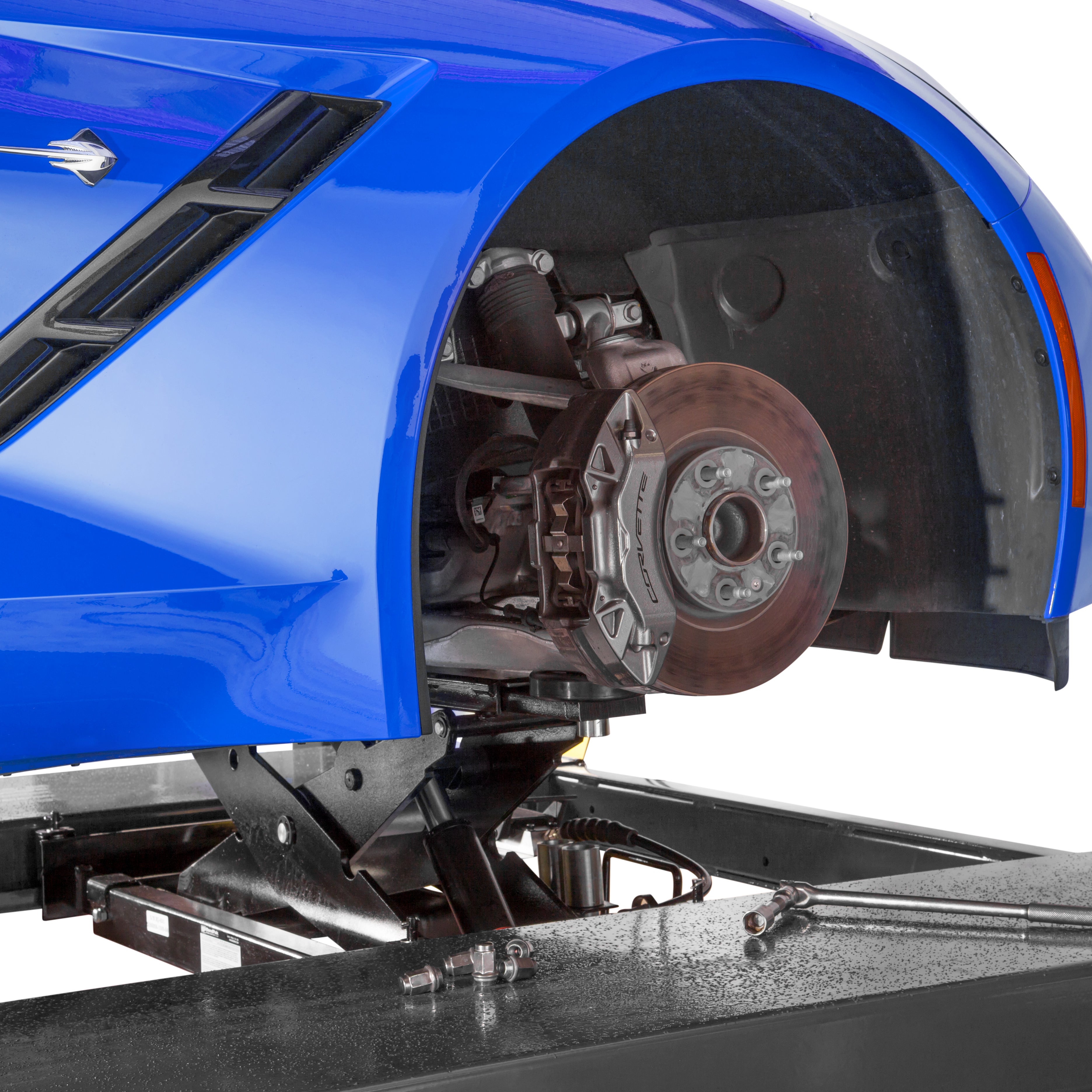 BendPak RJ7W rolling bridge jack raising a sports car for wheel-free service access.