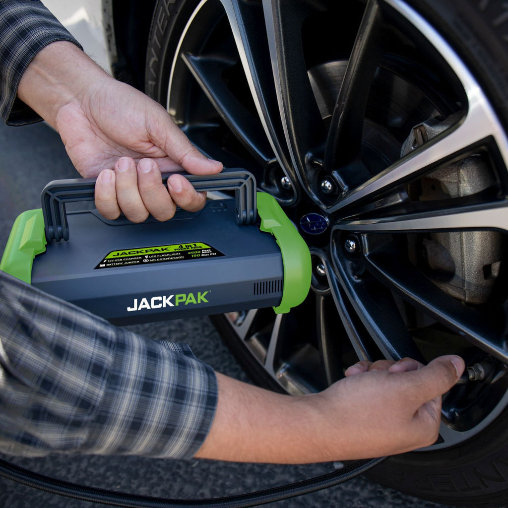 JackPak Ultra2500A air compressor inflating a car tire during roadside service
