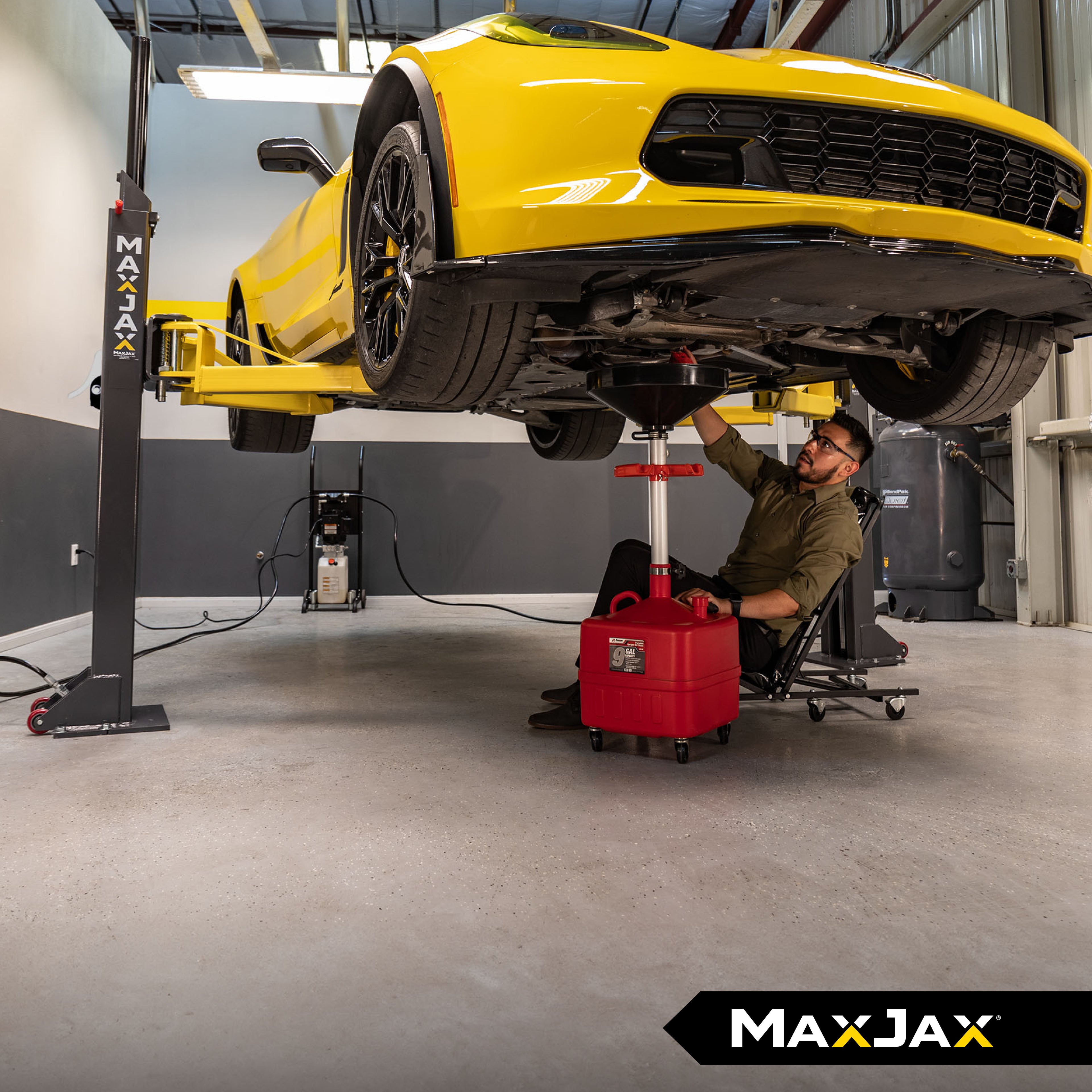 MaxJax M7K portable two-post lift raising a vehicle in a home garage with 7,000-lb. lifting capacity.