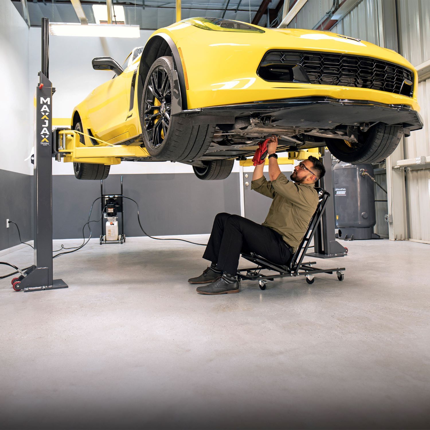 MaxJax M7K 7,000-lbs. portable two-post lift in use with a vehicle