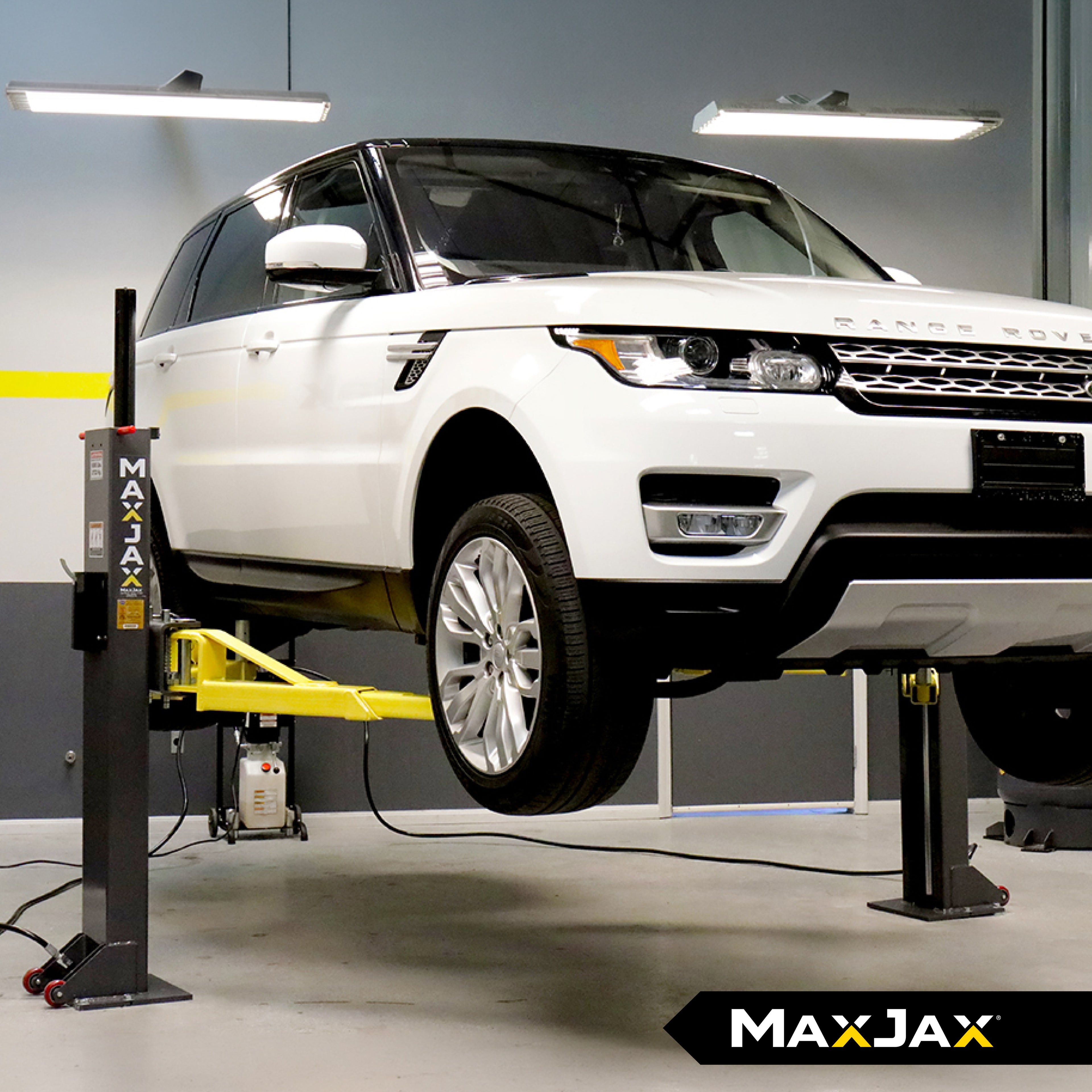 MaxJax M7K Deluxe portable two-post car lift set up for residential garage vehicle service.