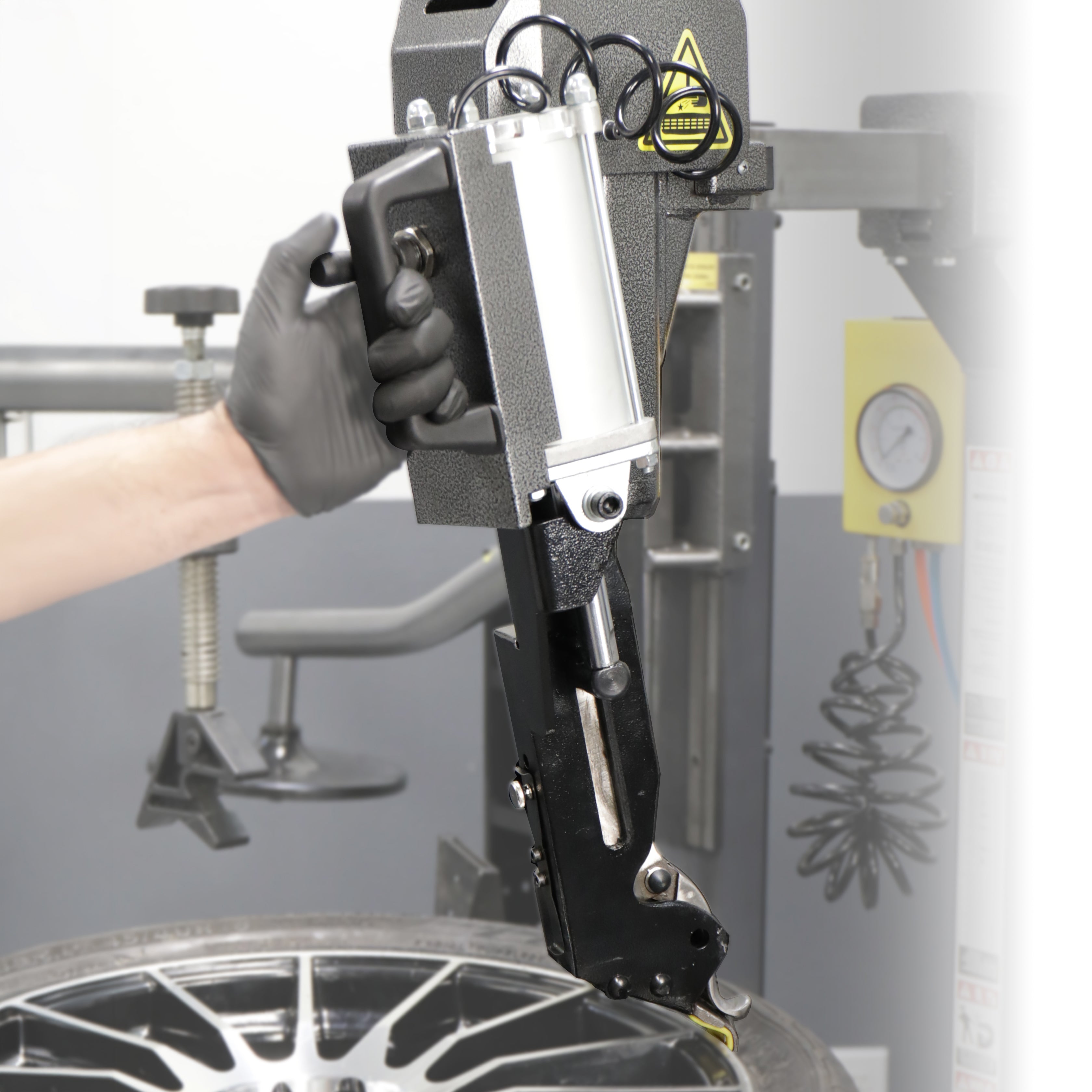 Ranger leverless auto bead lifter kit shown with operator during tire changer service