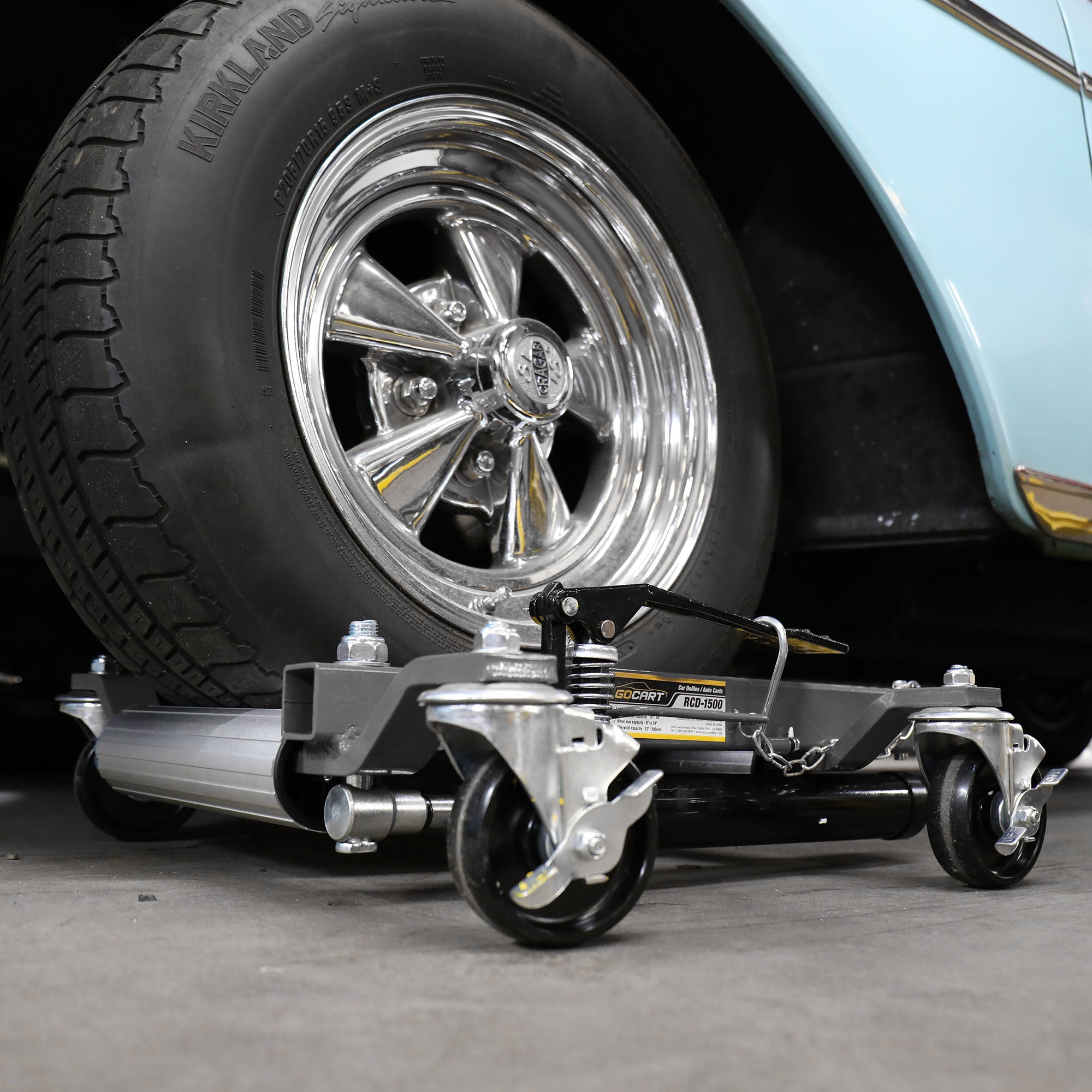 Ranger RCD-1500 car dolly supporting a vehicle tire for easy positioning in the shop