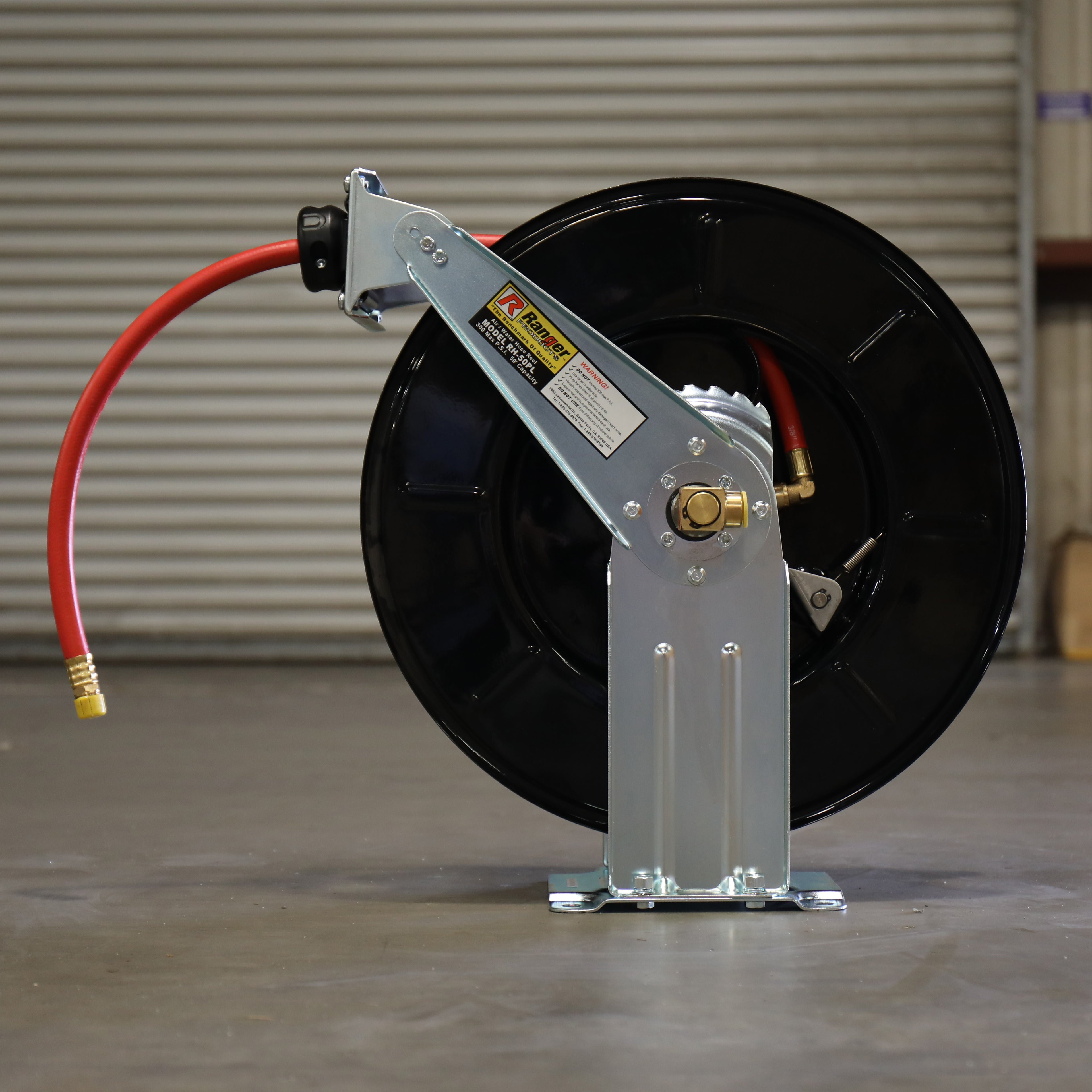 Ranger RH-50PL retractable air hose reel with the hose partially extended, showing the heavy-duty reel and mounting base for workshop air line management.