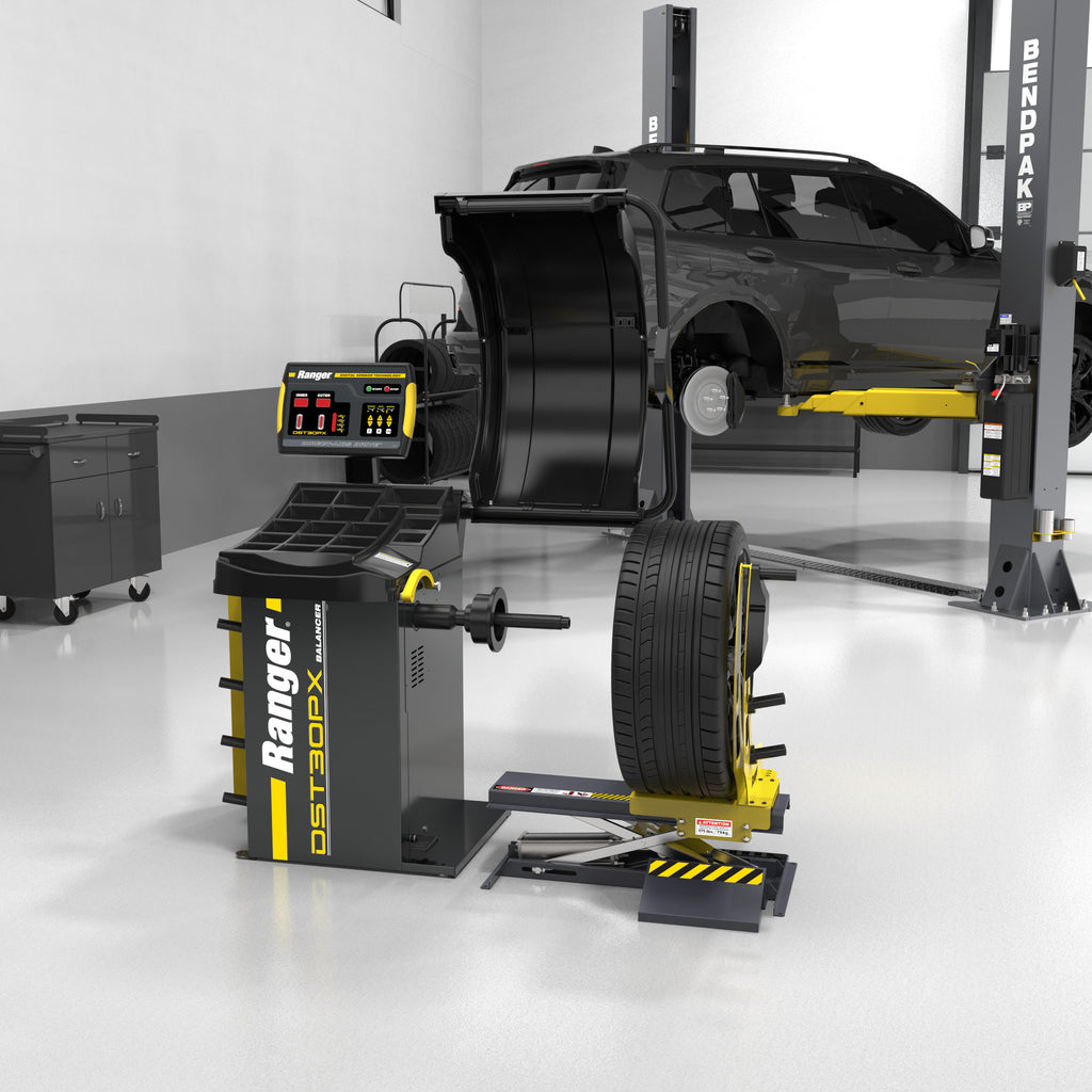 Ranger RWL-175 wheel lift in a shop bay for moving and positioning heavy tires.