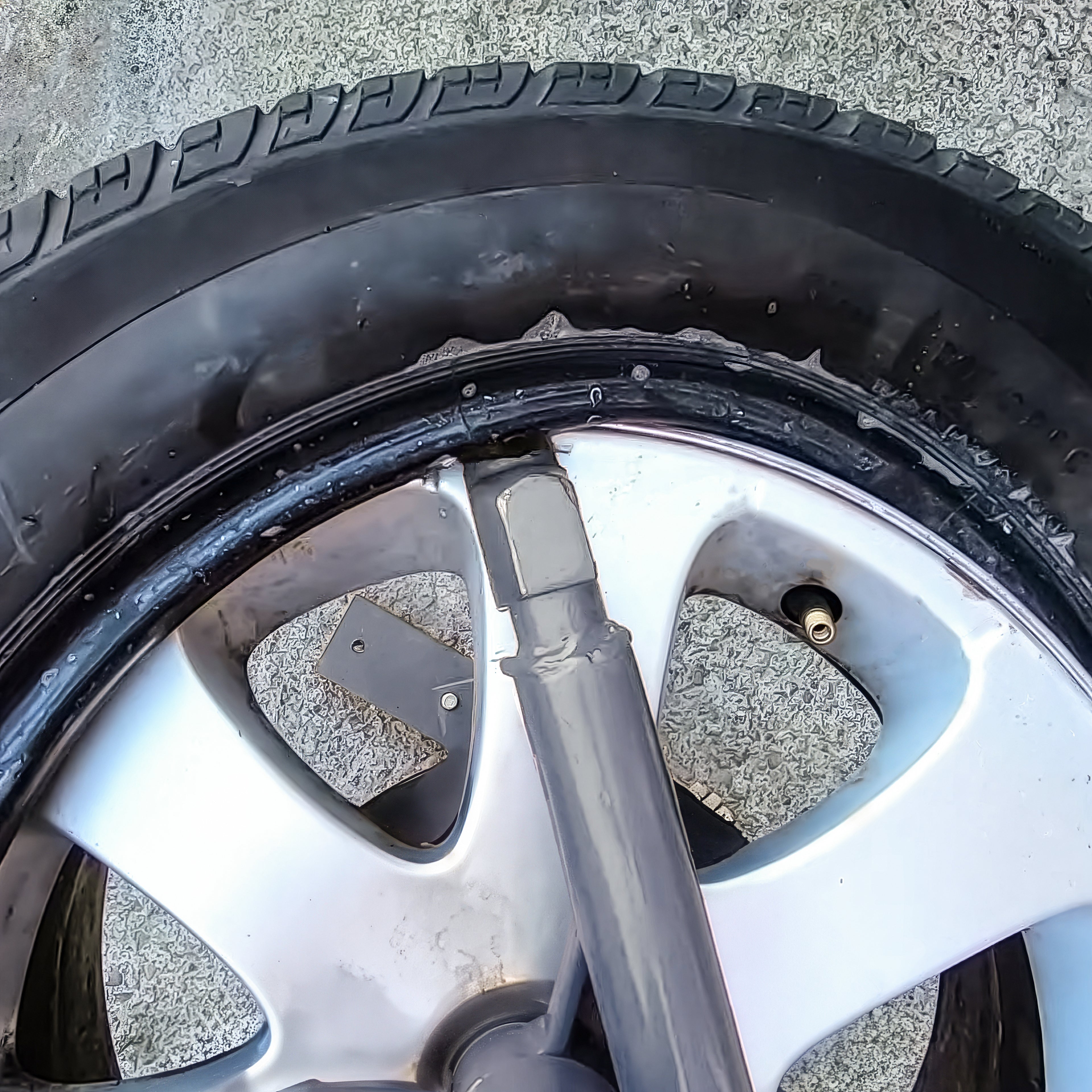 Ranger RWS-3TC manual tire changer shown lifting tire bead during service